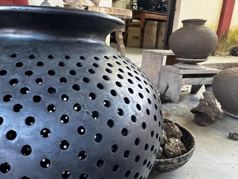 A pierced black clay pot of the kind fired at San Bartolo Coyotepec