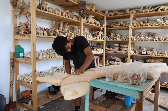 Shelves of finished black clay pieces in a village workshop