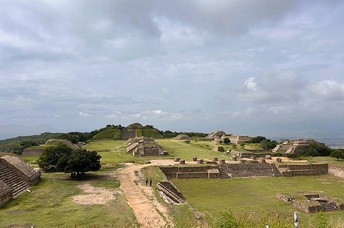 The Monte Alban plaza under a heavy sky, the ridge falling away on both sides